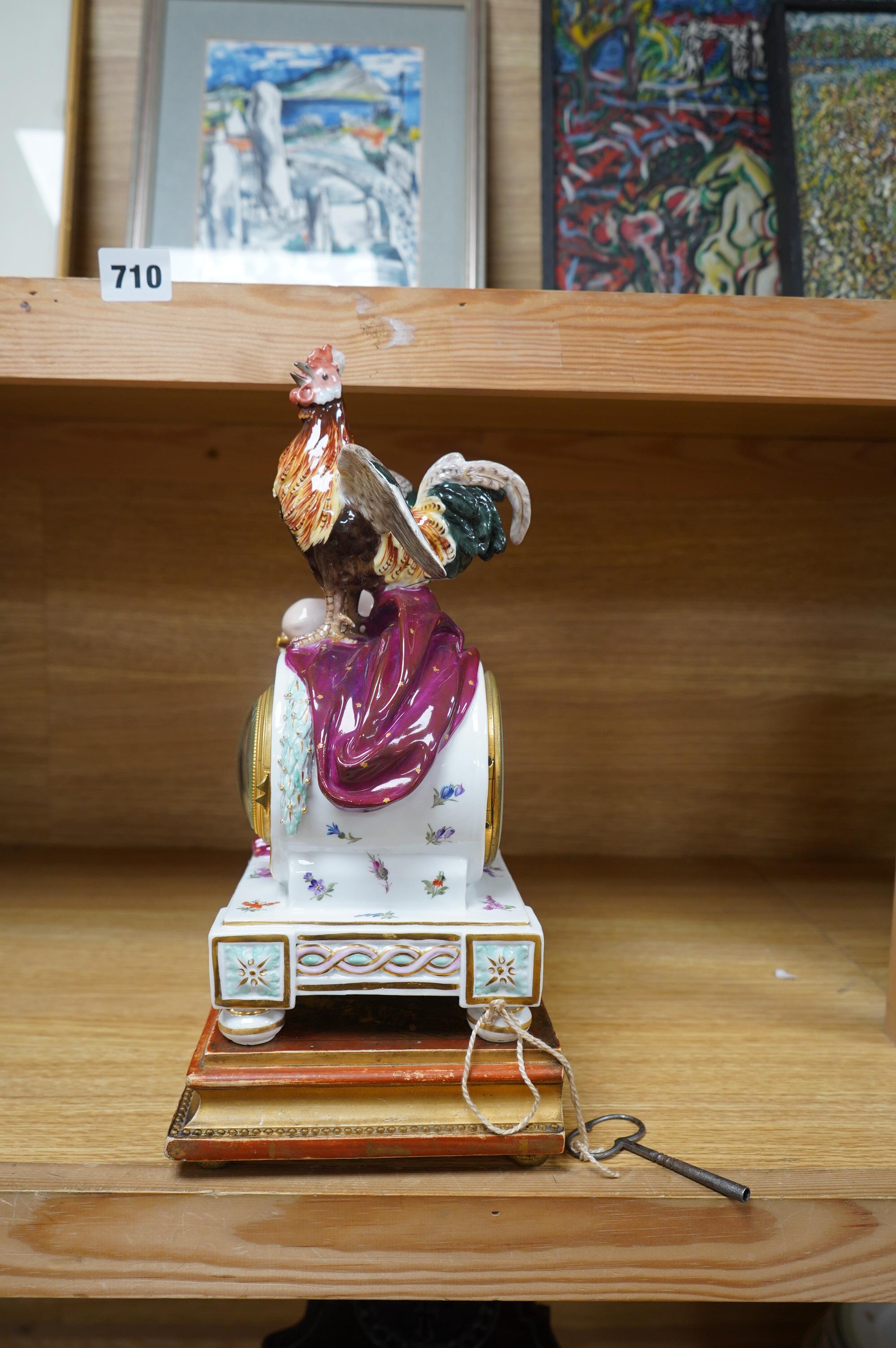 A Meissen figural mantel clock with cockerel surmount, French movement striking on a bell, 29cm high. Condition - poor